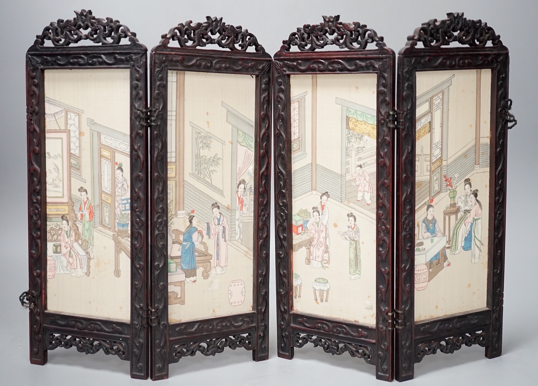 A Chinese hardwood framed painted silk four fold miniature screen, inset with painted silk panels, 28cm
